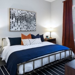 a bedroom with a bed and a nightstand